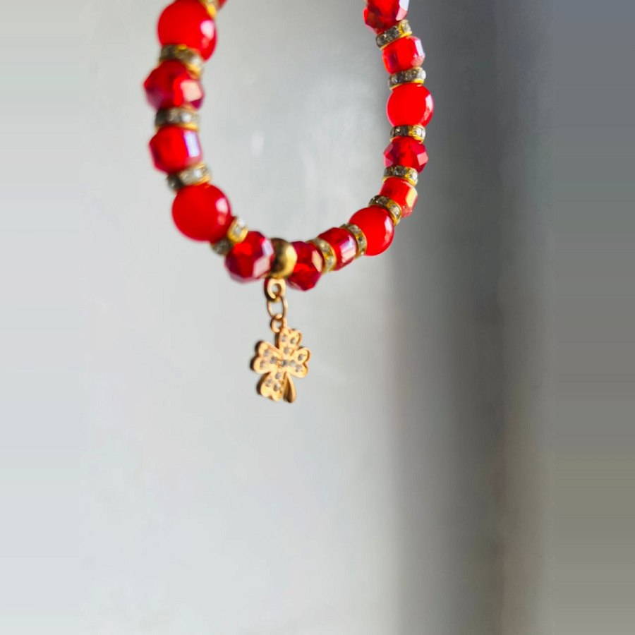 Red Crystal Bracelet With Gold Clover Charm from Afrikart
